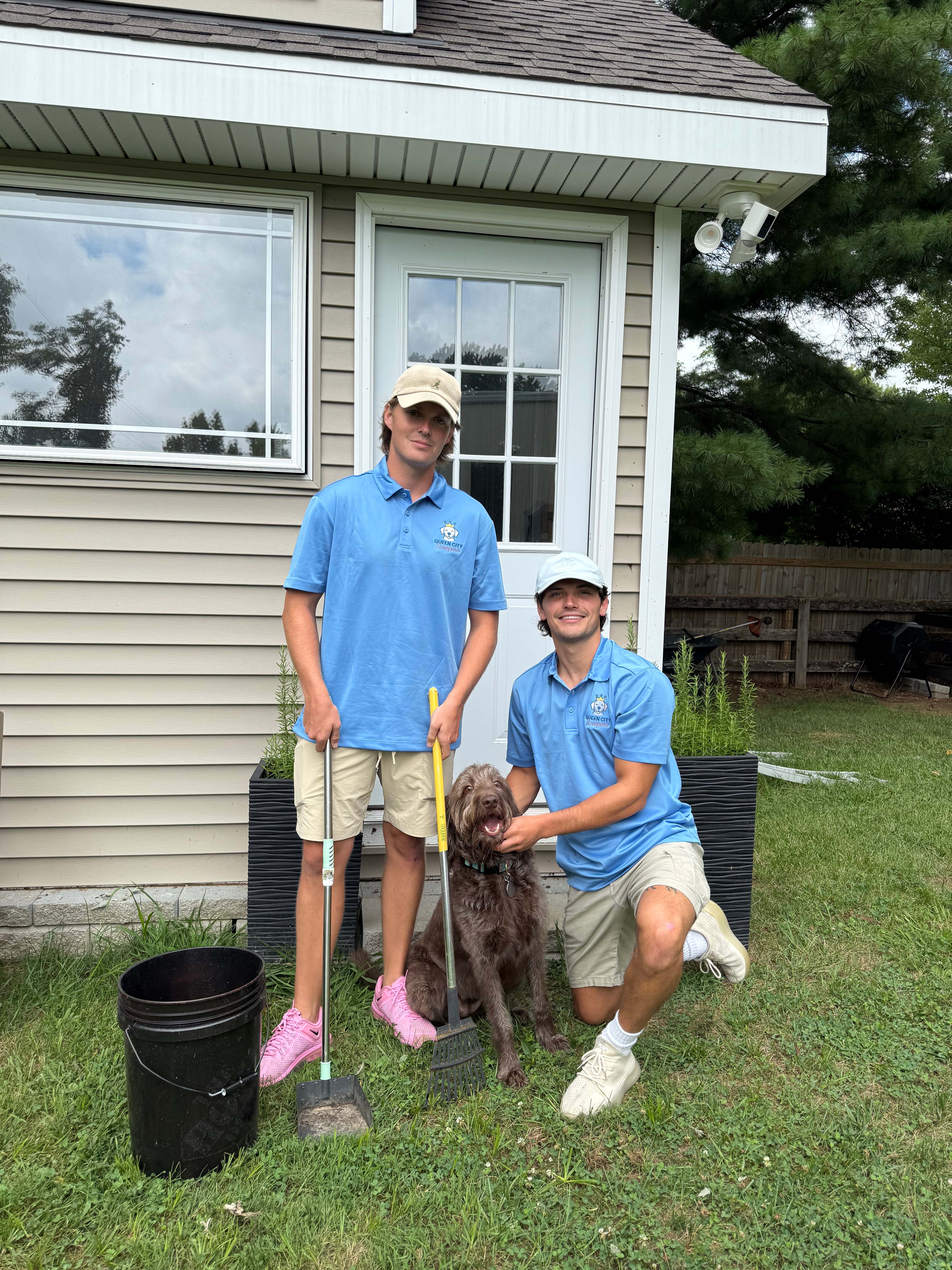 Queen City Scoopers team with professional equipment and friendly customer's dog